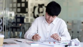 Young Asian graphic designer working on computor and graphics tablet in his working space - Powered by Shutterstock - Get 15% off with code: PIKWIZARD15