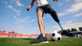 Football, soccer practice of a man with a bionic leg - Powered by Shutterstock - Get 15% off with code: PIKWIZARD15