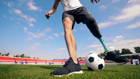 Football, soccer practice of a man with a bionic leg