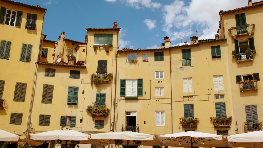 Walking towards the Piazza dell Anfiteatro in Lucca, Tuscany, Italy, the base of the former Roman amphitheater