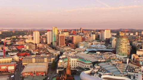 birmingham aerial view drone flying backwards from bullring grand central at sunrise