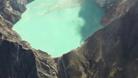 Ijen Volcano, Crater. Birch Sulfur Lake Kawah Ijen. Flight over the lake, video shooting from the air. Java Island, Indonesia.