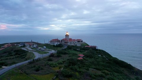 Evening view over the lighthouse of Cabo da Roca in Portugal - aerial drone footage