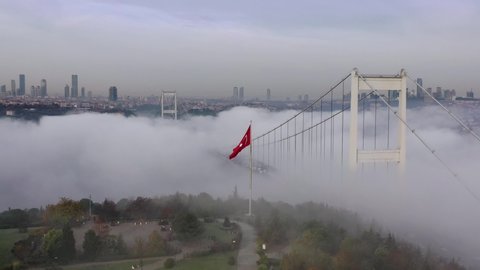 aerial video of Fatih Sultan Mehmet Bridge on a foggy day in Istanbul, Turkey. 2rd Bosphorus Bridge and Turkish Flag