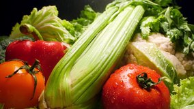 Closeup 4k footage of sprinkling water on fresh vegetables. Water droplets falling on cabbage, tomato, lettuce, celery and pepper. Concept of healthy nutrition and organic food. Perfect background  - Powered by Shutterstock - Get 15% off with code: PIKWIZARD15