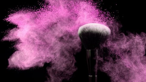 Super Slow Motion Shot of Pink Makeup Powder Falling from Facial Brush at 1000fps.
