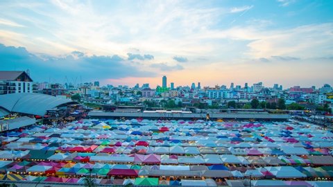 Time lapse Train night market Ratchada during twilight sky.Famous street market in Bangkok and tourist attraction.