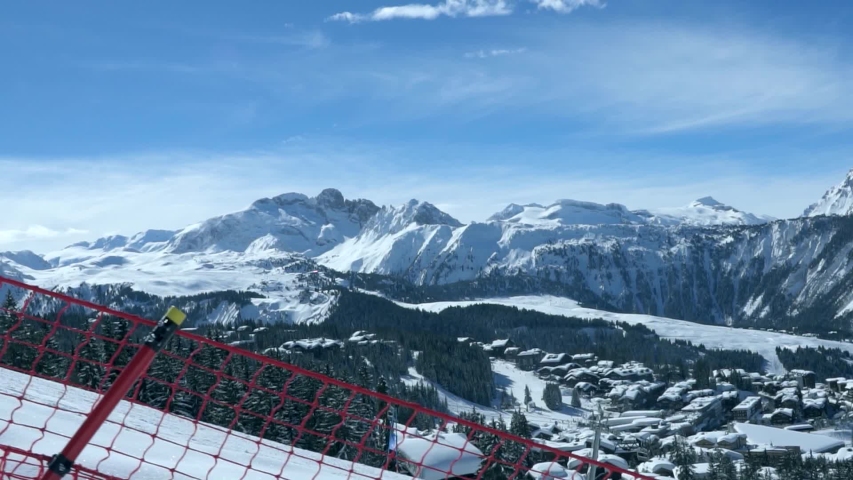Courchevel France November 19, 2019: skiers and snowboarders on the snowy alpine slopes. The winter vacation. Sportswear skier. Individual winter sports. Snow-covered conifers. Skier school. Blue sky Royalty-Free Stock Footage #1041279628