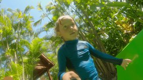 Little boy vlogger shoots a selfie video on a water slide in an aqua park. Slowmotion shot