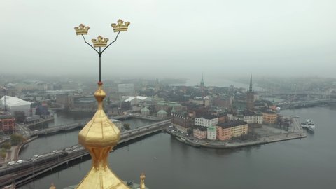 Stockholm Stadshuset Town City Hall close up drone shot of golden roof top and three crown flags
