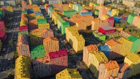 Colorful houses in Comfort Town district in Kyiv. Panoramic aerial view of colorful (red, green, blue, yellow) buildings on city street. Top aerial view panoramic video. Horizontal panorama.