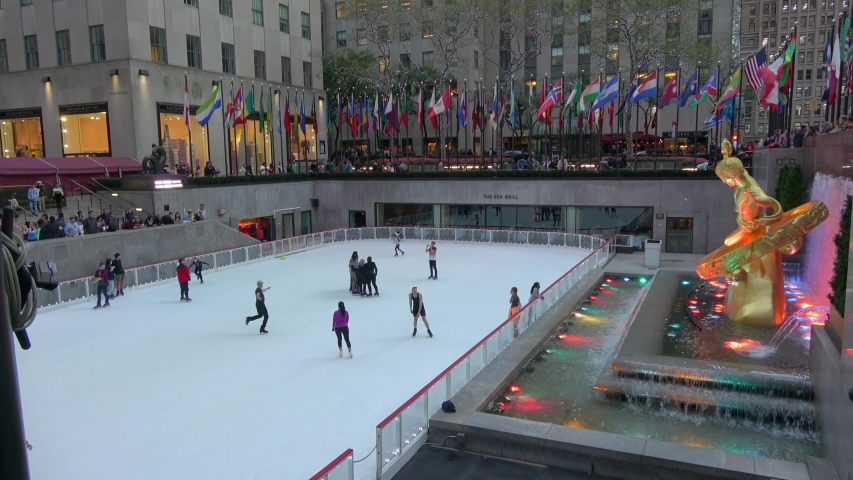 New York, U.S.A - October 19,2019: Locals and visitors gather around the Rockefeller Center Christmas tree and the ice skating rink in New York City. People skating on ice.