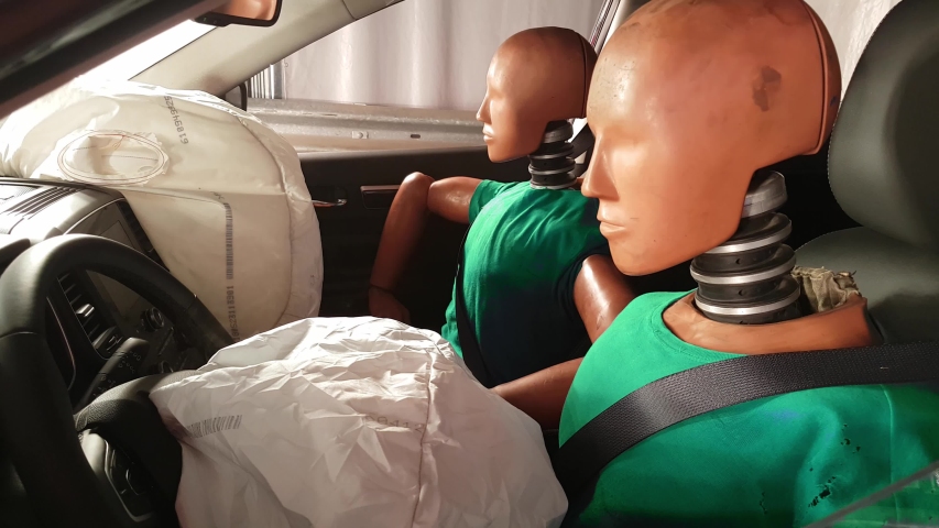 mannequins in a car after crash test. Smoke coming out of an airbag after an accident Royalty-Free Stock Footage #1041303679