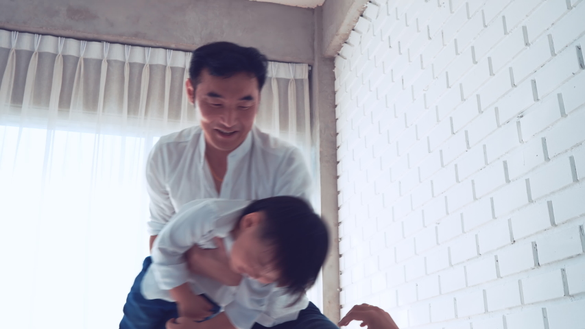 Happy Family funny together carry, Dad and Mon playing with son having fun at home in bedroom relaxing enjoy laughing cinematic Slow motion footage