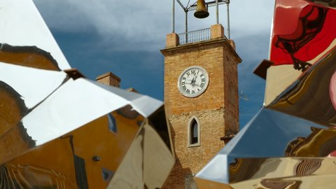 Close-up shot of the clock tower in the medieval town Lajatico, Tuscany, Italy, the home town of tenor Andrea Bocelli