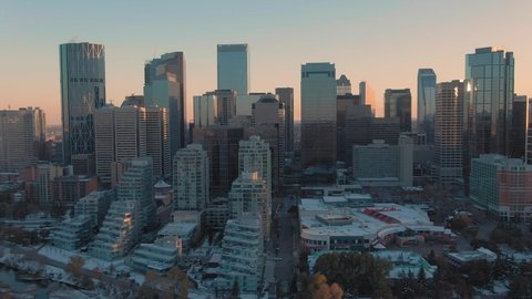 Aerial: Establishing shot of the Calgary city skyline at sunset. Calgary, Alberta, Canada. 1 April 2019 