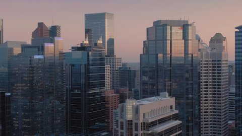 Aerial: Establishing shot of the Calgary city skyline at sunset. Calgary, Alberta, Canada. 1 April 2019 