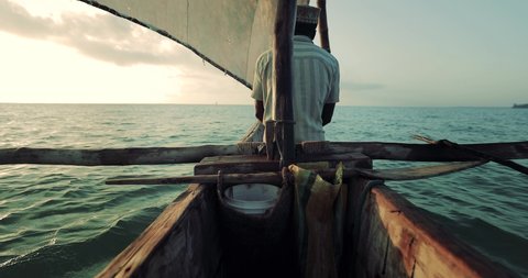 Fishermen's wooden dhow sailing at sunset in Zanzibar
Zanzibar is a Tanzanian archipelago off the coast of East Africa