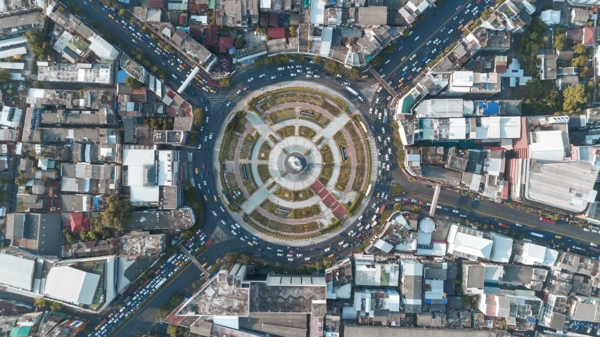 Hyperlapse timelapse moving go right circular of night city traffic on 4-way stop street intersection circle roundabout in bangkok, 4K UHD horizontal aerial view. Royalty-Free Stock Footage #1041330160