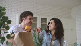Happy couple cooking breakfast at home. Close up of young family having fun at home kitchen. Smiling man and woman playing with food in slow motion. - Powered by Shutterstock - Get 15% off with code: PIKWIZARD15
