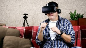 Portrait of man in vr glasses boxing moving hands enjoying digital sports. Modern gadgets, young people and entertainment concept.