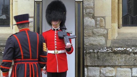 London, UK - April, 2019: Yeoman Warder at the Tower of London speaks with British guards. Beefeater approaches the British soldier and gives instructions. Queen's Guard - Tower of London.