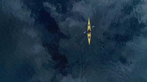 Straight down birds eye view from drone on lonely yellow kayak or canoe, young man paddles in clean reflection water of fjord in norway, scandinavian outdoors healthy lifestyle