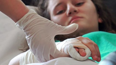 4k Doctor examining kid's broken hand. The patient with pain face in hospital bed. UHD stock footage
