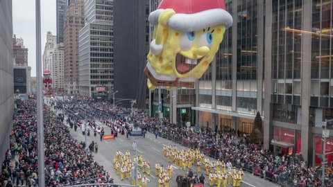 NEW YORK CITY - NOVEMBER 2016: Timelapse of Macy's Thanksgiving Day Parade Balloons marching on 6th Avenue with SpongeBob SquarePants,  The Elf on the Shelf balloon and others in New York City, USA