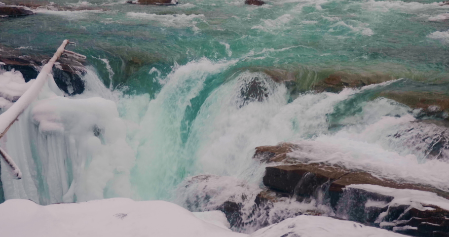 Turquoise Winter River Flowing Down Rocks at Athabasca Falls in Jasper National Park Alberta Canada
