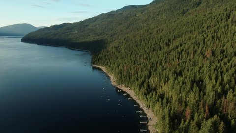 Aerial Drone Shot of Shuswap Lake Beach Front with Cabin Docks and Boats in Summer British Columbia Canada Vacation Hotspot