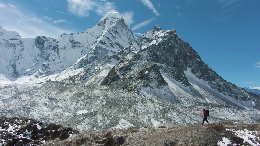 Ama Dablam Mountain and Hiking Man on Sunny Day. Blue Sky. Himalaya, Nepal. Aerial View. Drone Flies Sideways | Shutterstock HD Video #1041358444