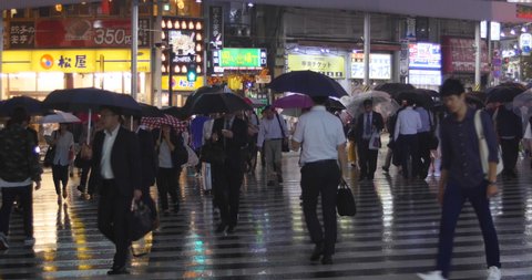 Tokyo, Japan. Circa October 2019: People Walking  In The Rain Downtown Tokyo, Japan. 