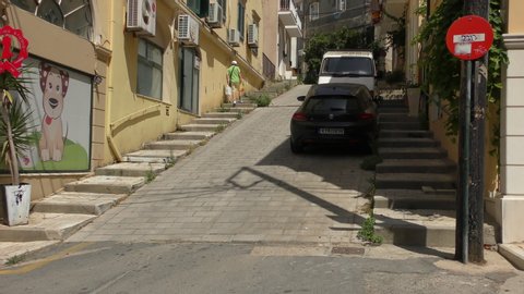 KERKYRA, GREECE - JULY 08, 2019: The streets of the old city of Kerkyra (Corfu Town), the main city of the island of Corfu. The  lane climbs steeply upwards.