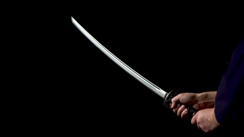 Japanese katana sword. Blade close-up on a dark background