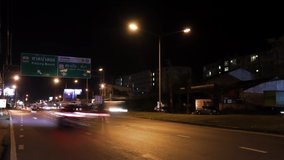Time lapse car driving at night on the road in Phuket - Thailand, have Thai language on the post for guide the way to Patong beach and airport