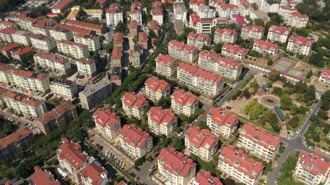 QINGDAO, CHINA – SEPTEMBER 2019: Drone flight over low-rise apartment blocks in residential area in Qingdao, China