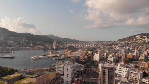 Aerial view in 4K of Nagasaki city in Japan. Skyscrapers and harbor of Nagasaki
