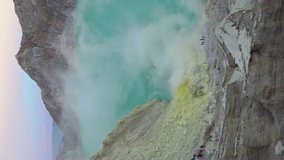 Vertical video. View on the crater of the Ijen volcano or Kawah Ijen with a big acid lake in it. Java island, Indonesia