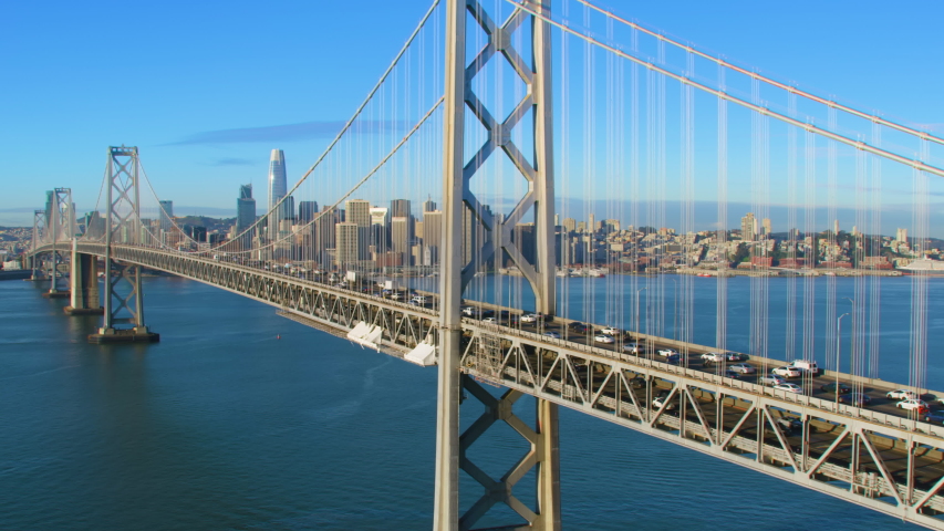 Aerial view of the San Francisco Oakland Bay Bridge full of traffic. Financial district skyline in the background. San Francisco, California. US.  Shot on Red weapon 8K.