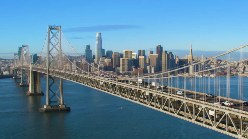 Aerial view of the San Francisco Oakland Bay Bridge full of traffic. Financial district skyline in the background. San Francisco, California. US.  Shot on Red weapon 8K.