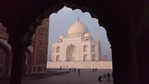 18 NOVEMBER 2019: Taj Mahal the famous UNESCO site walking inside the framing arch with the local people and tourist. Agra, India.