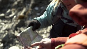 Healthy extreme Caucasian adventure couple wearing casual clothing reading map on hike of Fjordland  - Powered by Shutterstock - Get 15% off with code: PIKWIZARD15