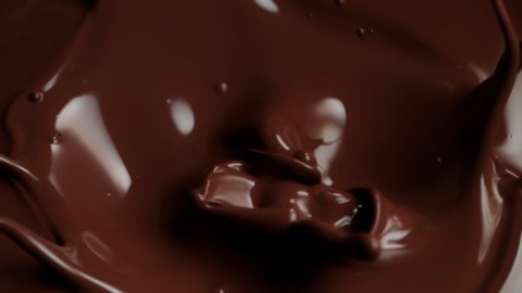 Super Slow Motion Shot of Raw Chocolate Chunks Falling into Melted Chocolate at 1000fps.