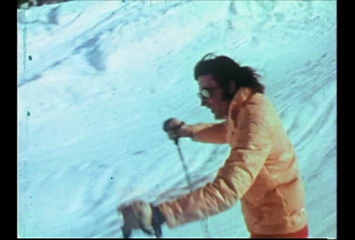 Salt Lake City, Utah, circa 1974.  Vintage film footage from a tourism video of hip, hot-dog expert skiers jumping, and skiing fast at Utah ski resorts. 
