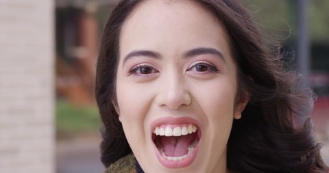 Close up - Young attractive woman breaks into laughter and a beautiful smile. - Slow Motion - shot on RED