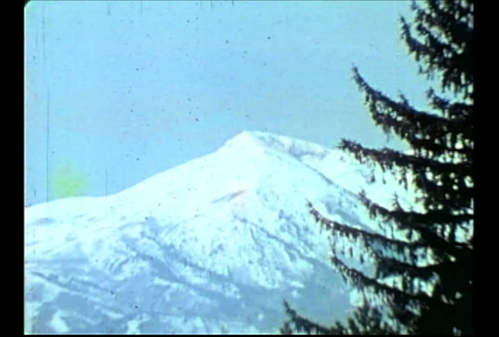Salt Lake City, Utah, circa 1974.  Vintage film footage from a tourism video of hip, hot-dog expert skiers jumping, and skiing fast at Utah ski resorts. 
