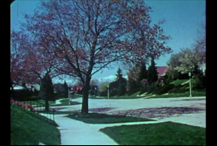Salt Lake City, Utah, circa 1974.  Vintage film footage of a nice Salt Lake City neighborood with the Wasatch Mountains in background.
