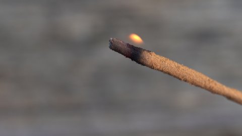 Close up of an Incense stick burning outside