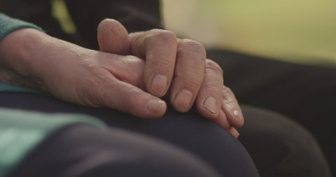 4K Faithful old couple holding hands. Close-up of hands of lovely aged couple caring and loving each other. Support trust in marriage relationship. Beautiful footage. Health care concept. Slow Motion.